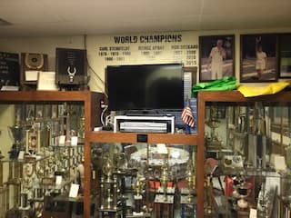 A "World Champions" board mounted above trophy cases lining the clubhouse walls